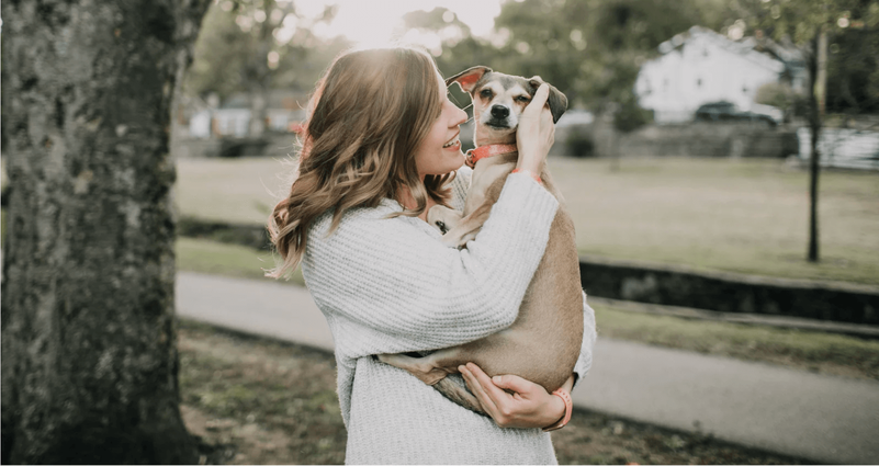 Owner giving her dog a hug